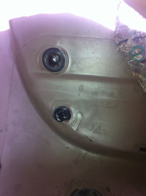 1996 Ford Bronco - Close-up of an interior trim panel with visible fasteners and carpeted material.