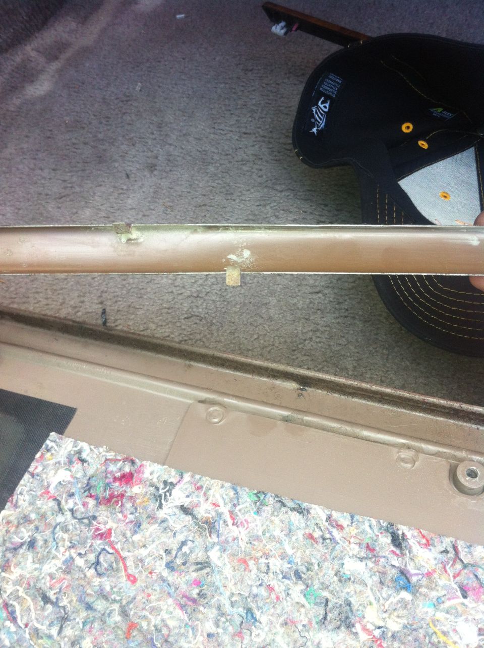 Tan interior trim piece with visible clips and wear