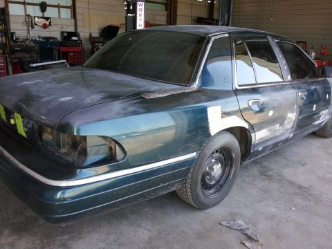 1994 Mercury Grand Marquis - This sedan is in a garage, with visible bodywork and primer on its exterior panels.