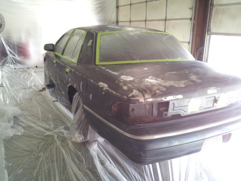 1994 Mercury Grand Marquis - This sedan is undergoing bodywork and is covered in masking tape and primer, ready for a new paint job.