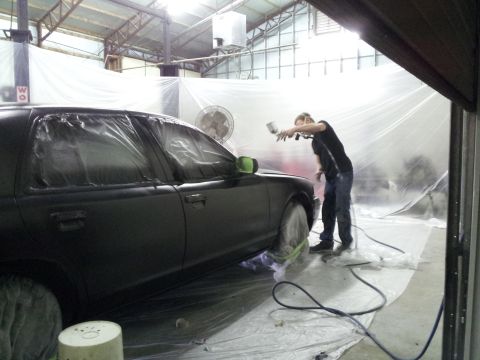 1994 Mercury Grand Marquis - Car is being prepped for paint in a spray booth, with plastic covering the windows and wheels.