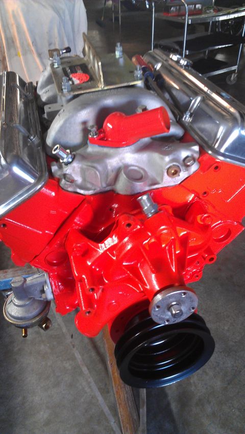 1973 Chevrolet Camaro - This is a close-up view of a V8 engine, showing the intake manifold, valve covers, and a pulley system.