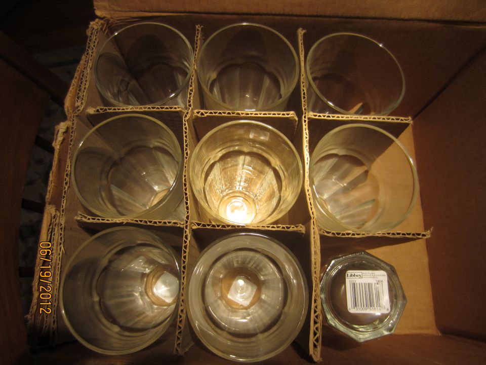 Nine glasses in a cardboard box with dividers. A date stamp reads 06/19/2012