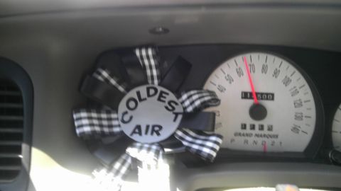 2000 Mercury Grand Marquis - The speedometer shows the car is moving, with an air freshener attached to the dashboard.
