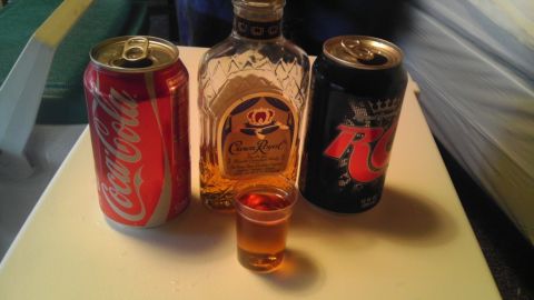 2000 Mercury Grand Marquis - A collection of beverages including Coca-Cola, Crown Royal, and RC Cola, along with a shot glass.