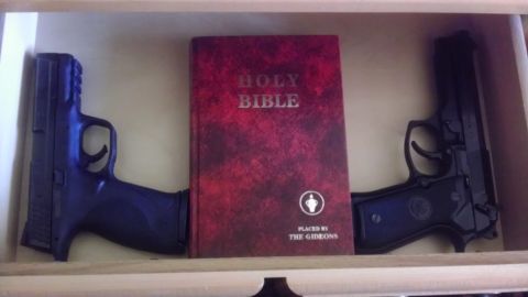 2000 Mercury Grand Marquis - A Holy Bible is placed between two handguns in a drawer.