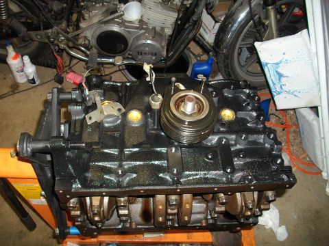 1989 Ford Probe - Engine block assembly with visible crankshaft and oil filter housing, mounted on an orange stand.