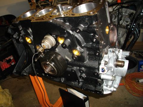 1989 Ford Probe - Engine block assembly, likely undergoing rebuild or maintenance, is mounted on an orange stand for accessibility.