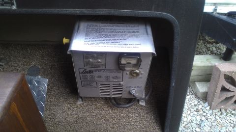 1991 Chevrolet Cheyenne - A Lester battery charger is visible inside a compartment, a gauge and instructional label.