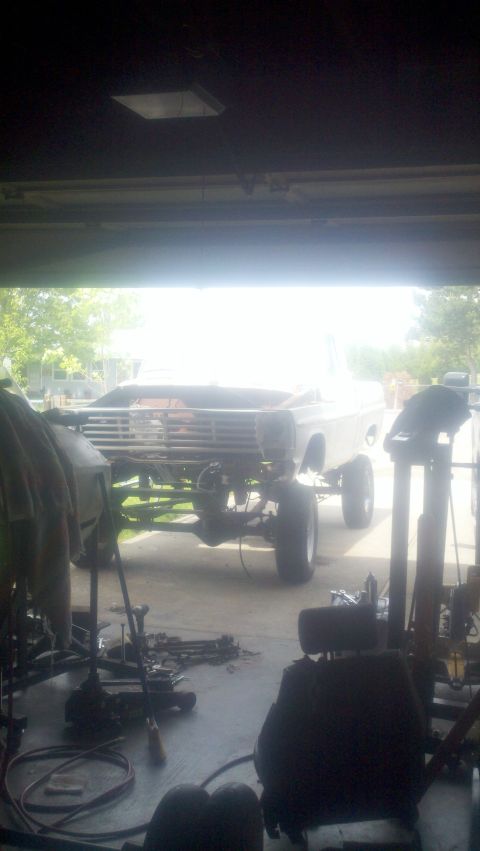 1967 Ford F-250 - A truck is in a garage, appearing to be undergoing repairs or restoration, with various parts scattered around.