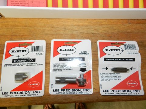 1996 Ford Bronco - Collection of three Lee Precision reloading tools, including a chamfer tool, case trimmer, and primer pocket cleaner, displayed on a wooden…
