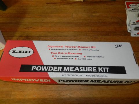 1996 Ford Bronco - A box for a Lee Powder Measure Kit is shown on a wooden surface, with other boxes in the background.