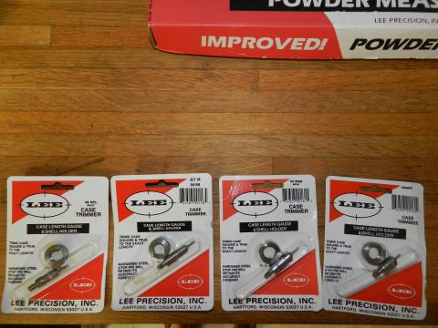 1996 Ford Bronco - Four packages of Lee Precision case trimmers and shell holders are displayed on a wooden surface.
