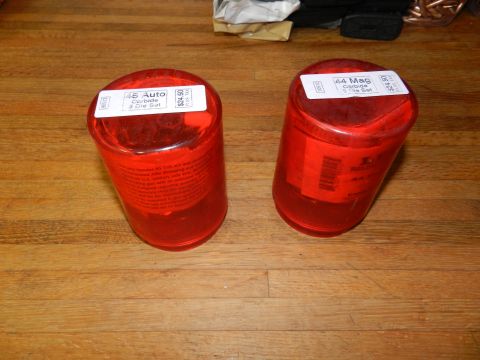 1996 Ford Bronco - Two red plastic containers, one labeled '45 Auto Carbide 3 Die Set' and the other '44 Mag Carbide 3 Die Set', sit on a wooden surface.