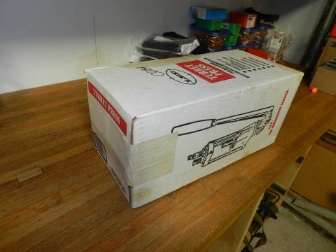 1996 Ford Bronco - A box labeled "TURRET PRESS" sits on a wooden table, with other items on a shelf in the background.