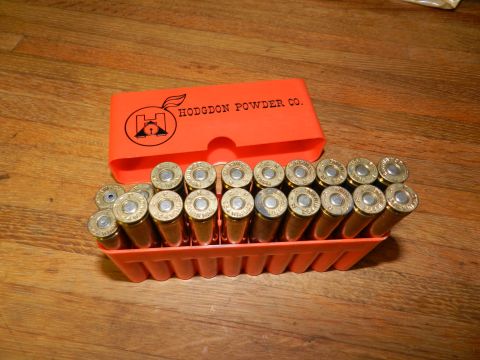 1996 Ford Bronco - Hodgdon Powder Co. ammunition box with cartridges displayed on a wooden surface.