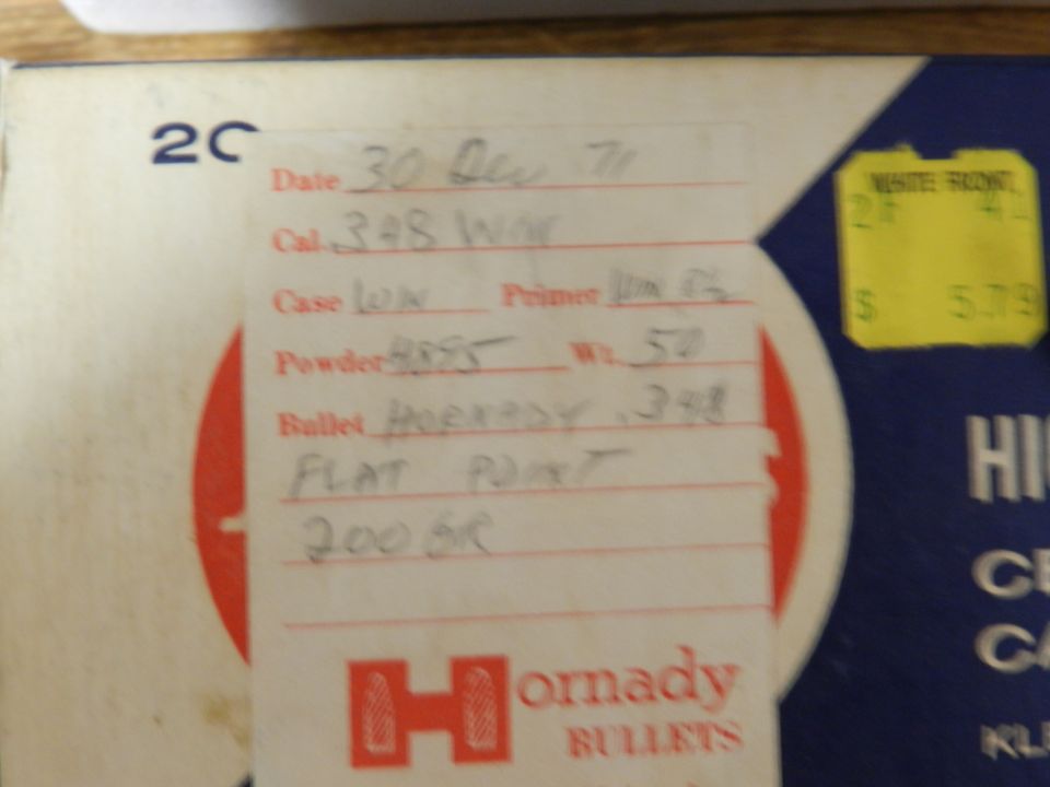 Handwritten reloading data for .348 Win cartridge, including powder and bullet details, on a Hornady box