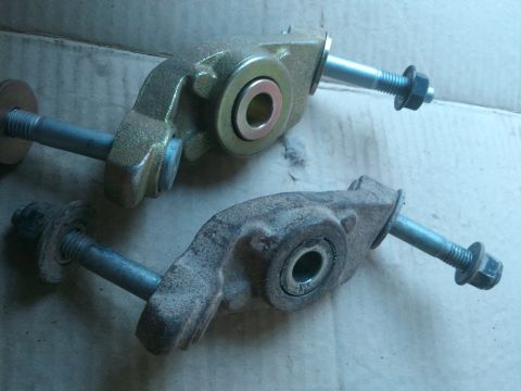 1998 Ford Crown Victoria - Comparison of a new and used automotive suspension control arm, likely for a rear axle.