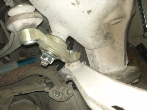 1998 Ford Crown Victoria - A detailed view of a vehicle's suspension system, focusing on a specific mechanical part.