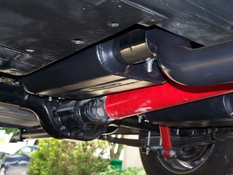 1971 Ford Ranchero - The photo shows the undercarriage of a vehicle, focusing on the exhaust pipes and suspension system.