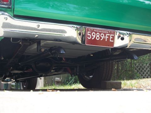 1971 Ford Ranchero - The rear of a green 1971 Ford Ranchero shows its chrome bumper and license plate.