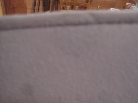 1993 Ford Bronco - Close-up of gray interior upholstery with a visible "SUPERMOTORS" logo and website.