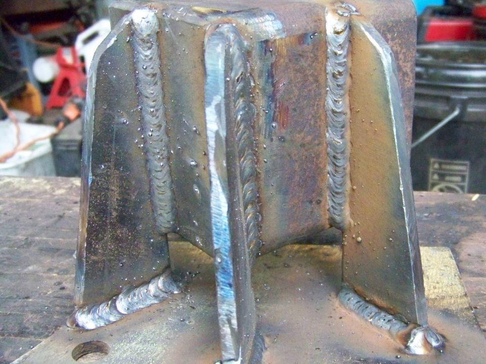 Welded metal bracket with visible weld beads and rust