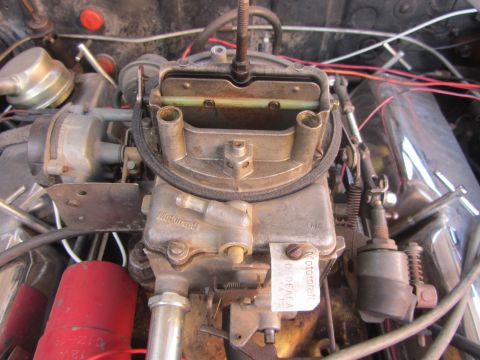 1964 Ford Ranchero - Close-up of a Ford Motorcraft carburetor, showing its intricate mechanical components and a legible part number tag.