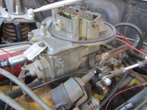 1964 Ford Ranchero - A detailed view of a carburetor, a crucial engine component, with visible labeling.