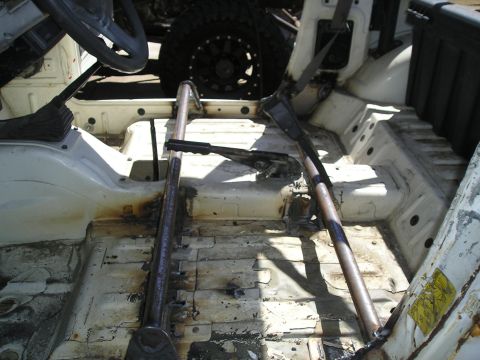 1987 Suzuki Samurai - Interior view of a 1987 Suzuki Samurai, stripped down with a roll cage installed.