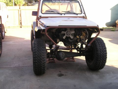 1987 Suzuki Samurai - This Suzuki Samurai is modified for off-roading and appears to be undergoing some mechanical work.