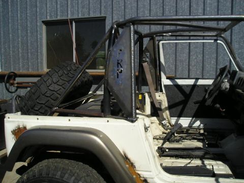 1987 Suzuki Samurai - This vehicle has been heavily modified with a roll cage and is missing interior components.