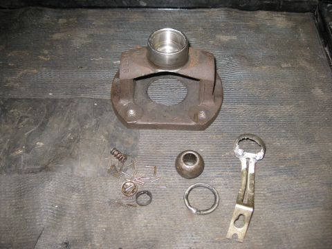 1994 Ford Bronco - Disassembled driveshaft components and tools are spread out on a dark, textured surface, ready for service.