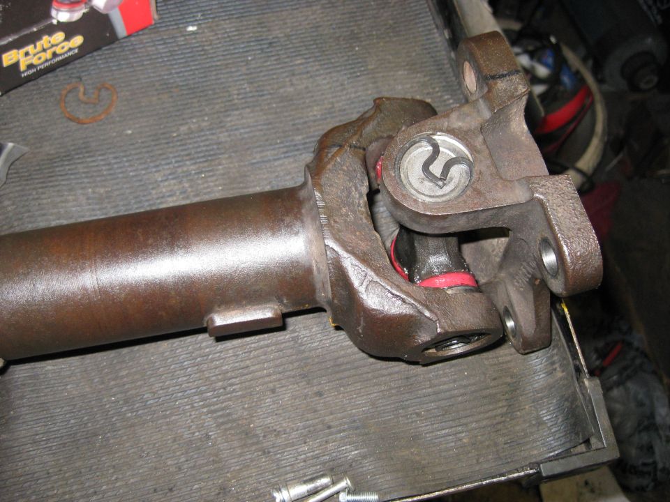 close-up of a driveshaft u-joint with red seals
