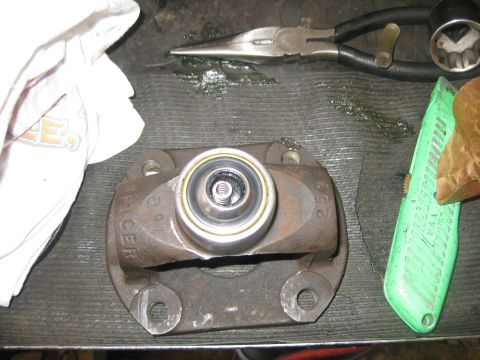 1994 Ford Bronco - A driveshaft part, possibly from a Spicer brand component, is shown with a bearing and tools for repair.