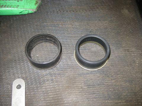 1994 Ford Bronco - Two rubber seals are laid out on a workbench, possibly for a driveshaft rebuild.