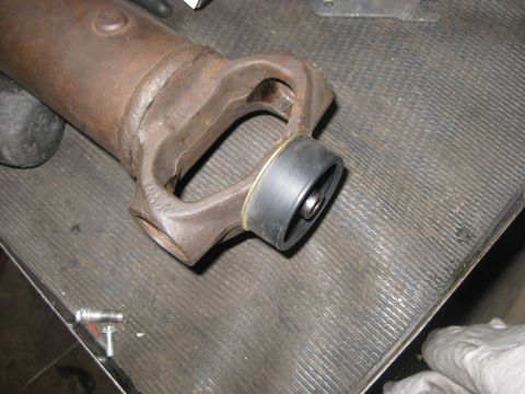 1994 Ford Bronco - A driveshaft yoke with a new rubber boot is shown, likely for a vehicle repair or maintenance.