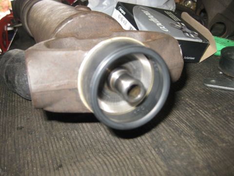 1994 Ford Bronco - Close-up of a driveshaft component, likely for a vehicle rebuild, with a box of parts visible.