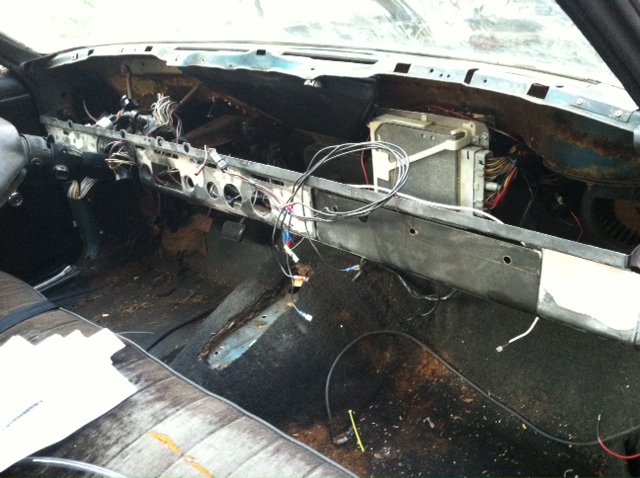 Mock up of more wiring. The EEC is pretty much in place. The dash harness was laid out. Wiring for aftermarked gauges, neutral safety switch (swapped from a C4 to a T5), and the VSS were being figured out here. 

Aftermarket gauges (oil pressure and water temp) are going in the lower dash (btw radio and glove box).