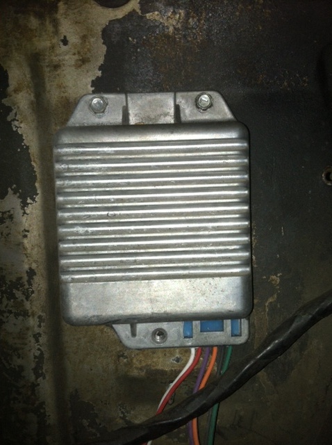 1993 Ford Bronco - Close-up of an engine control module, likely from a vehicle, with its connected wiring harness visible.