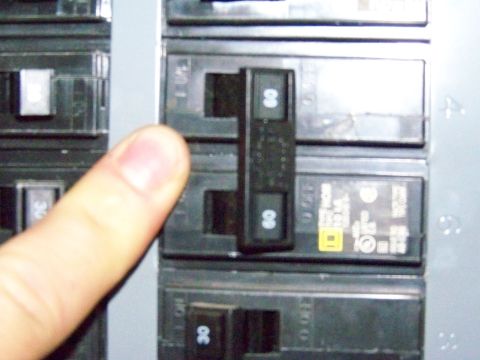 1985 Ford Bronco - A finger is shown pointing to a 60 amp circuit breaker within an electrical panel. The registry claims this is a 1985 Ford Bronco, but the…