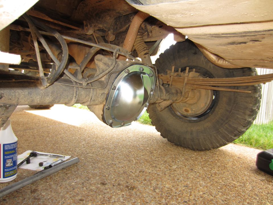 rear axle differential with shiny cover, leaf springs, and tire