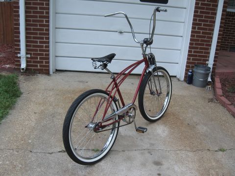 1994 Ford Bronco - A classic cruiser bicycle with a distinctive frame and high handlebars is shown in front of a garage door.