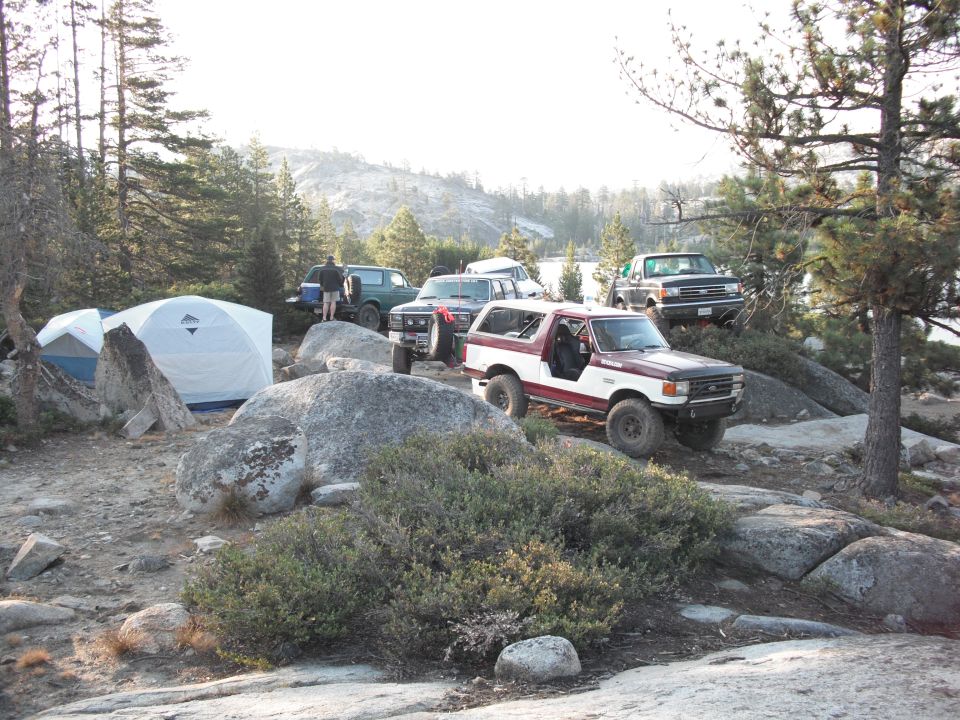 Red and white 1991 Ford Bronco parked on rocks, 3q-front view