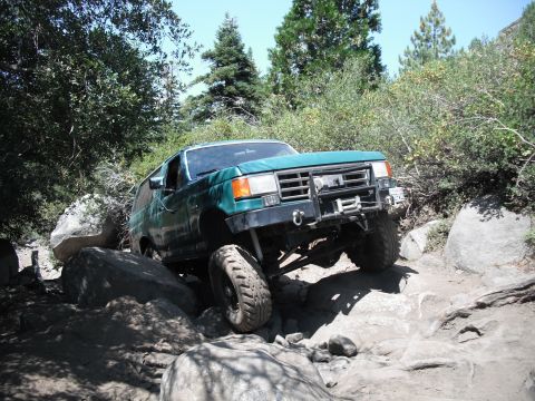 1991 Ford Bronco - Green 1991 Ford Bronco tackling a difficult rocky off-road path.