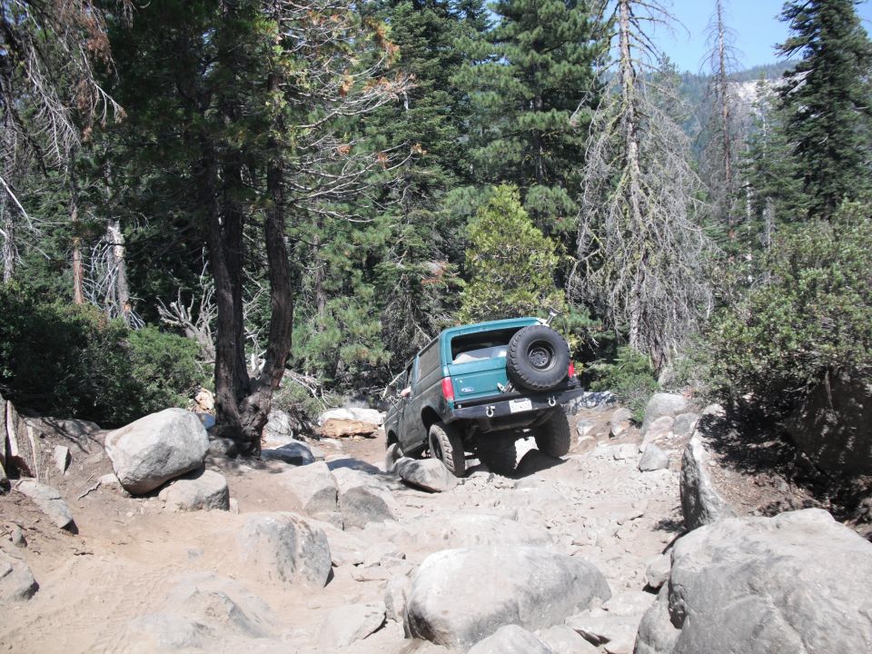 1991 Ford Bronco navigating a boulder-strewn mountain path