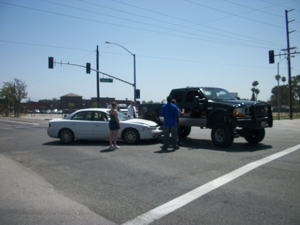 2001 Ford F-250 and a white sedan involved in an intersection accident