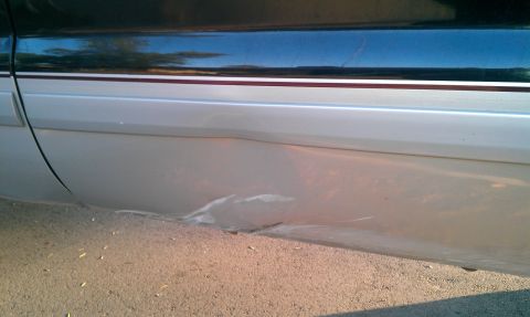 2001 Ford F-250 - The lower body panel shows significant damage and scraping.
