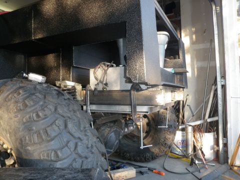 1961 International Scout 800 - Vehicle chassis and large tire are visible, with fuel tank and suspension components in view, suggesting ongoing construction or modificati…