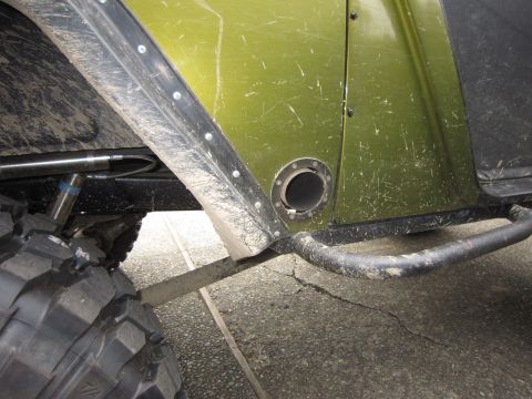 1974 Ford Bronco - Detail shot of a off-road vehicle's exterior, showing a large tire and part of the body.